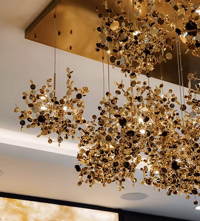 Sculptural gold pendant chandelier installation